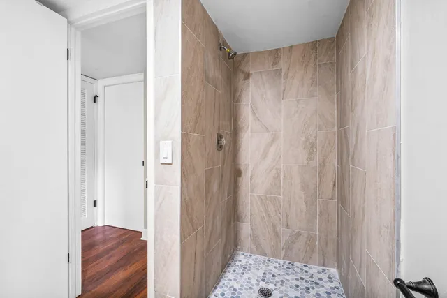 a view of bathroom with a shower and a bath tub