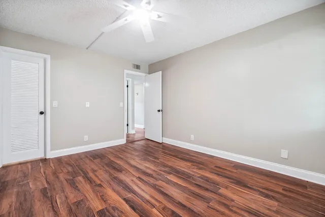 a view of an empty room with wooden floor