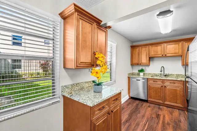 a kitchen with stainless steel appliances granite countertop sink stove top oven and cabinets