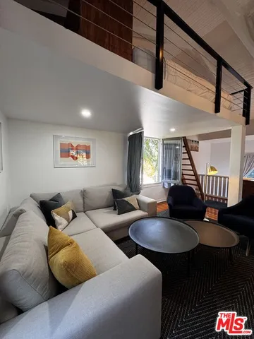 a living room with furniture and a rug