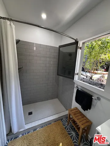 a bathroom with a shower and a sink