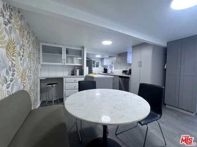 a kitchen with a table and chairs in it
