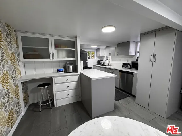 a kitchen with cabinets a sink and appliances