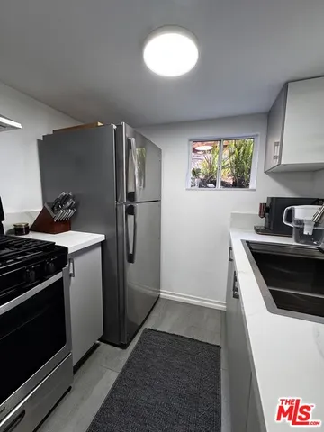 a kitchen with a stove and a refrigerator