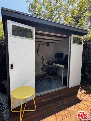 a view of a room with wooden floor and a chair