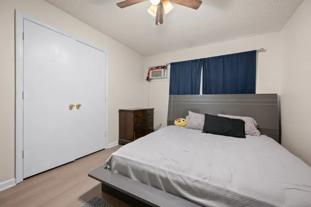 a bedroom with a bed and a chandelier