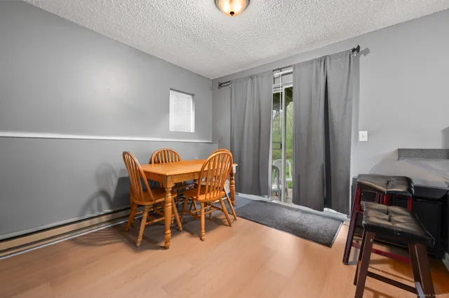 a view of a dining room with furniture and window
