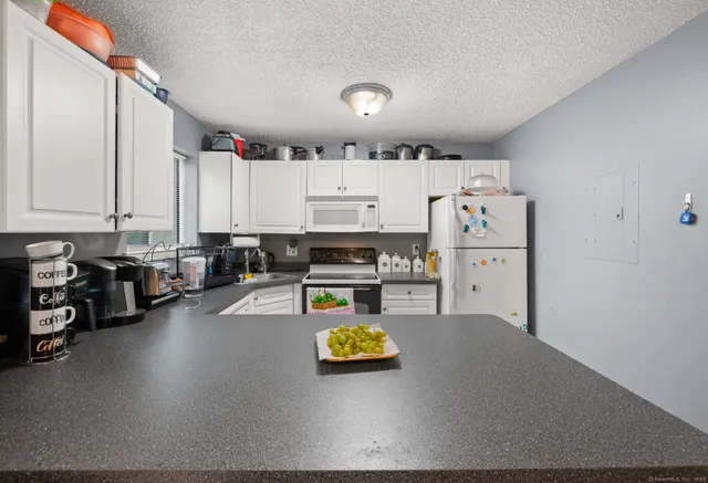 a kitchen with a refrigerator and a stove top oven