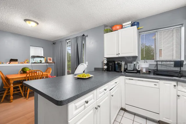 a kitchen with sink cabinets and dining table