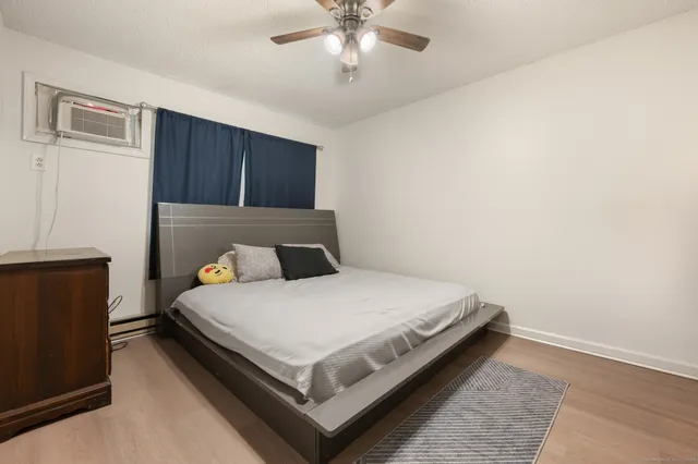 a large bed sitting in a bedroom next to a cabinet