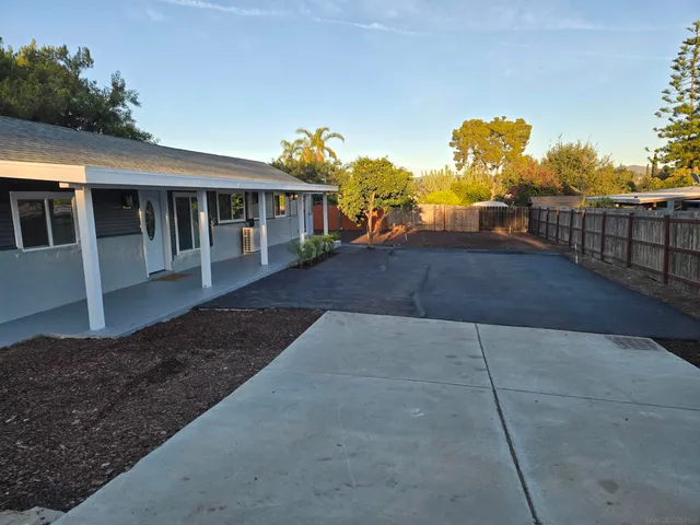 a front view of a house with a yard and seating space