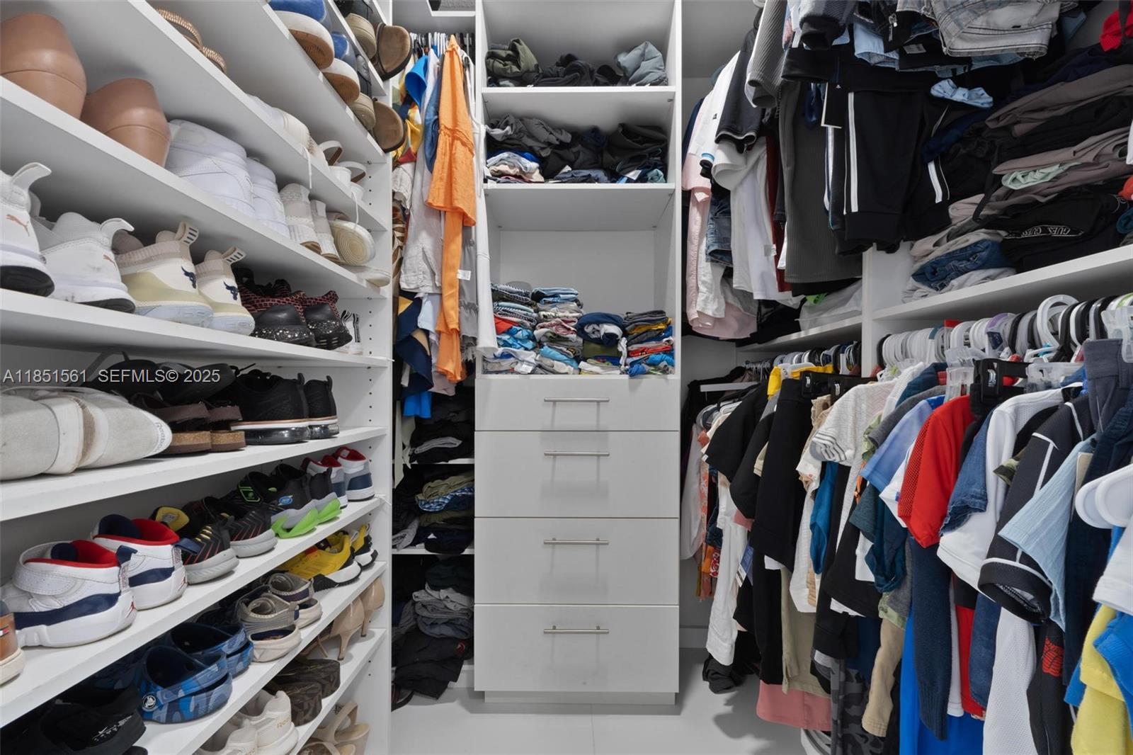 14725 Southwest 90th Terrace Miami, FL 33196 - Photo 32 of 50 a view of walk in closet with clothes and shoes