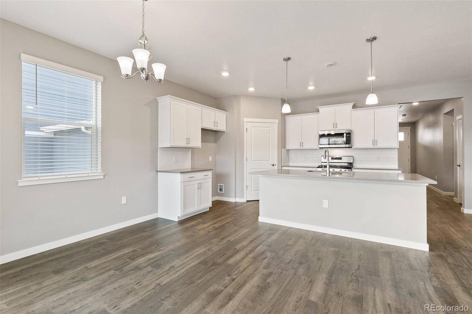 3458 Belleville Ridge Road Elizabeth, CO 80107 - Photo 11 of 27 a view of kitchen with granite countertop cabinets a counter top space stainless steel appliances and a chandelier