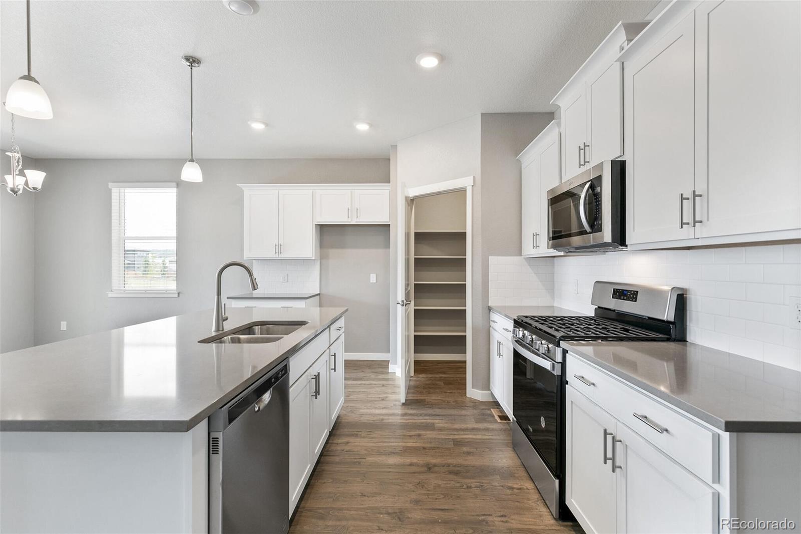 3458 Belleville Ridge Road Elizabeth, CO 80107 - Photo 13 of 27 a kitchen with stainless steel appliances granite countertop a sink stove and refrigerator