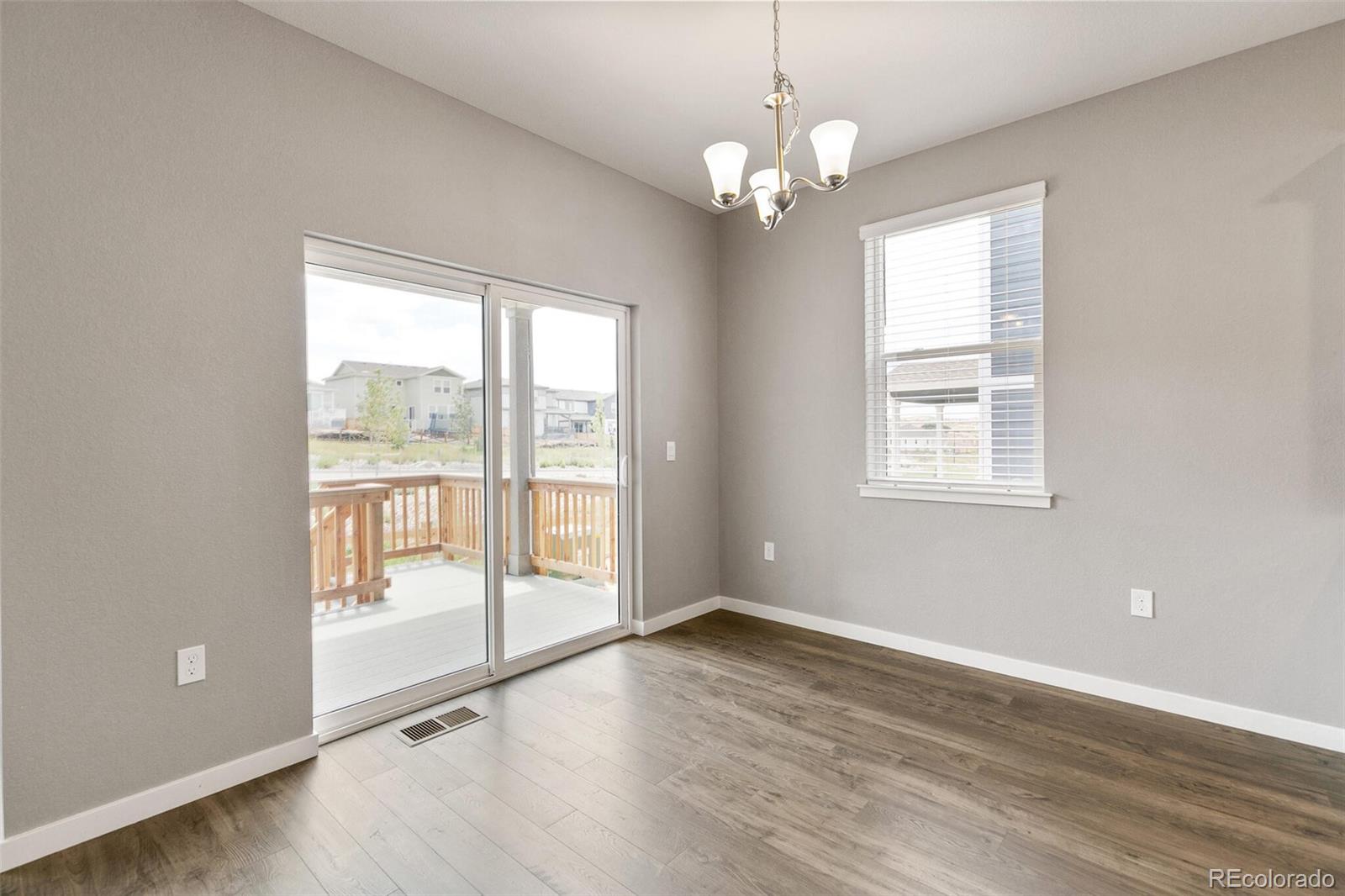 3458 Belleville Ridge Road Elizabeth, CO 80107 - Photo 16 of 27 a view of an empty room with wooden floor and a window