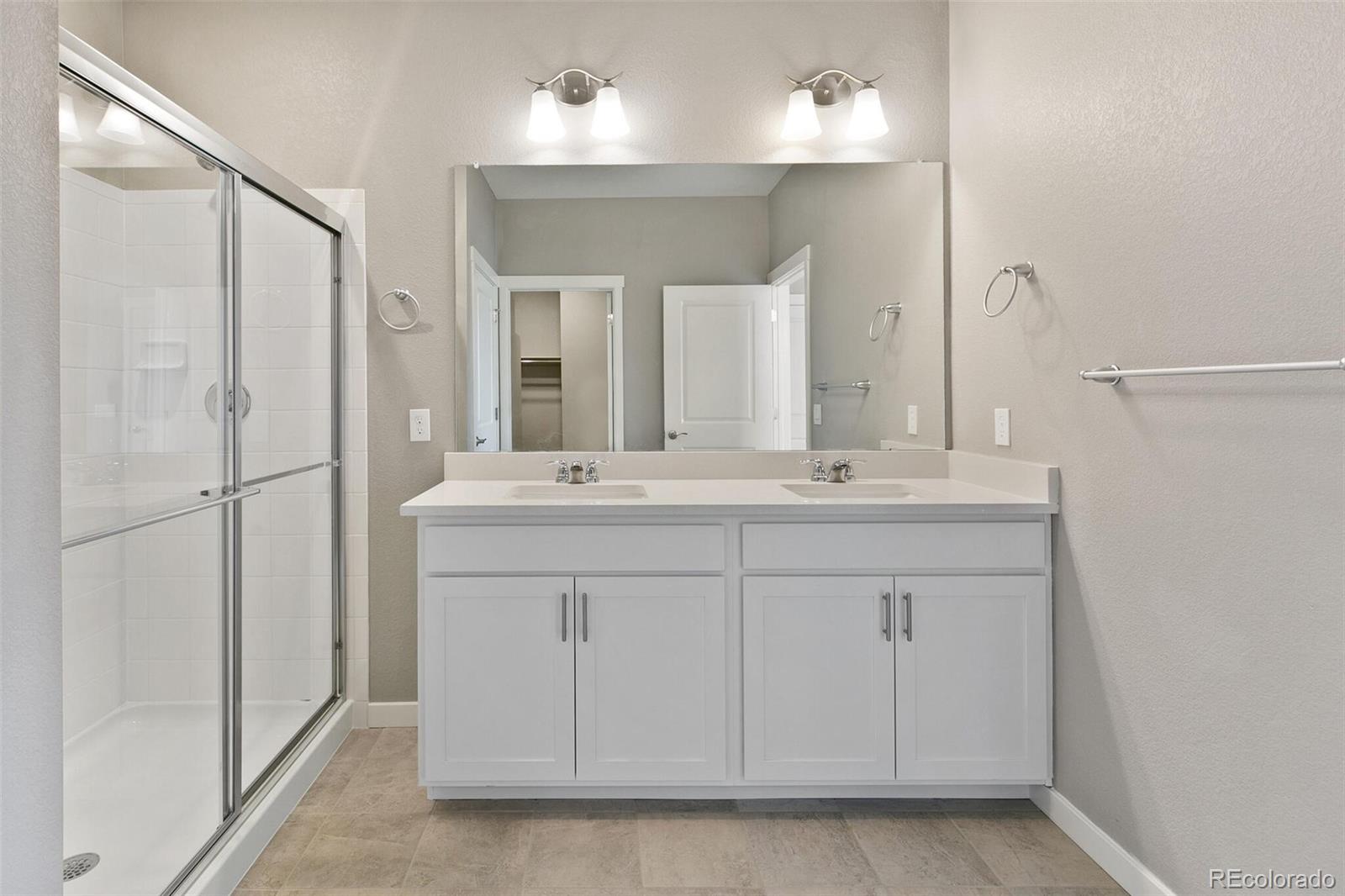3458 Belleville Ridge Road Elizabeth, CO 80107 - Photo 20 of 27 a bathroom with a double vanity sink mirror and double