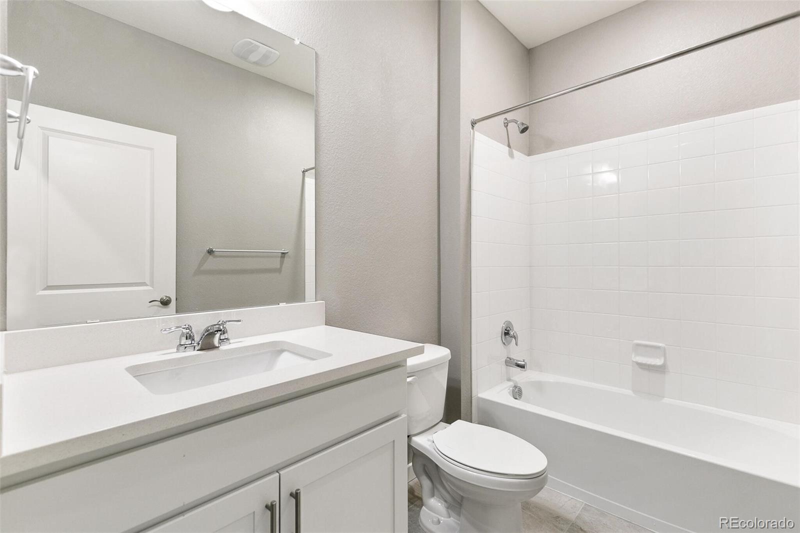 3458 Belleville Ridge Road Elizabeth, CO 80107 - Photo 23 of 27 a bathroom with a sink a toilet and a large mirror