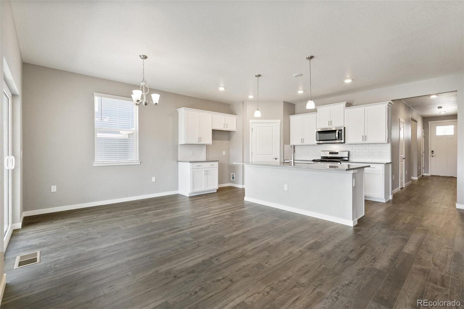 3458 Belleville Ridge Road Elizabeth, CO 80107 - Photo 7 of 27 a view of kitchen with granite countertop cabinets stainless steel appliances and wooden floor