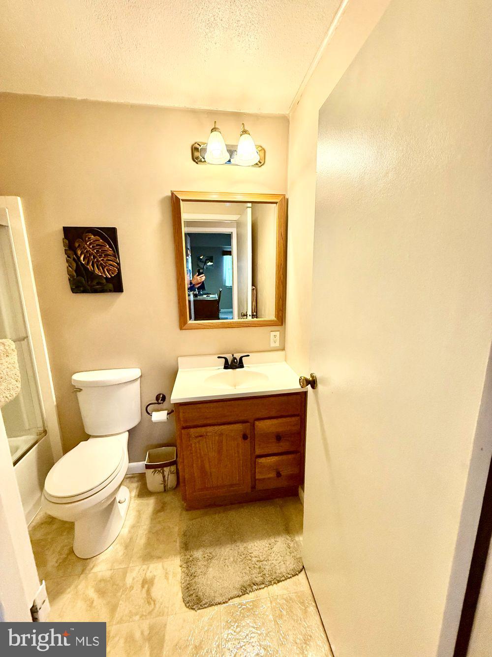 80 Welsh Tract Road, Unit G306 Newark, DE 19713 - Photo 9 of 11 a bathroom with a sink a toilet and a mirror