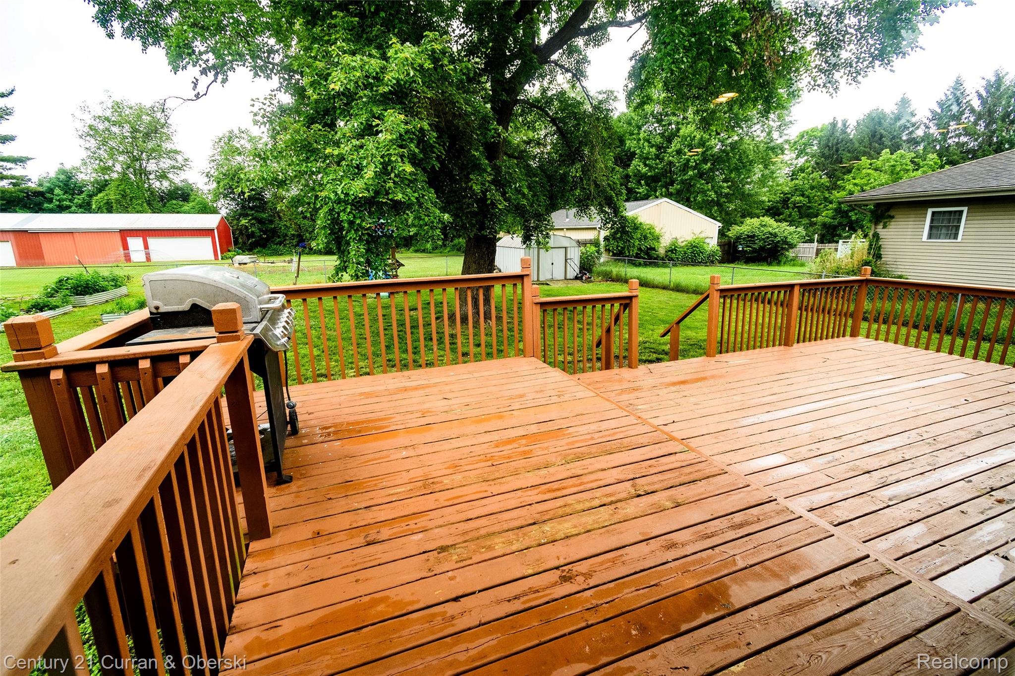 5260 Rives Junction Road Jackson, MI 49201 - Photo 39 of 44 Expansive multi-level wood deck with wood railings, overlooking a large grassy yard