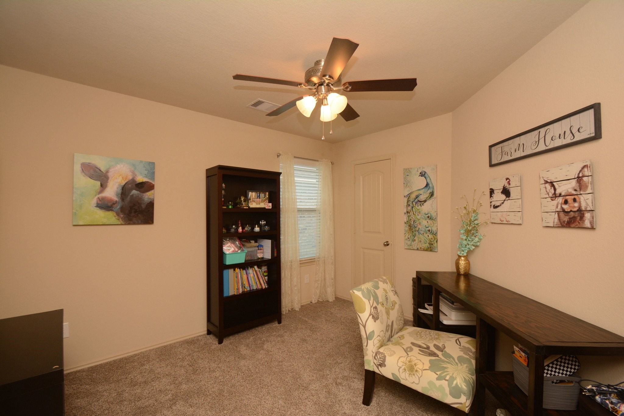 23318 Dukes Run Drive Spring, TX 77373 - Photo 22 of 41 This cozy room features soft carpeting and neutral walls, a ceiling fan, and ample natural light from a window, creating a warm, and inviting space.