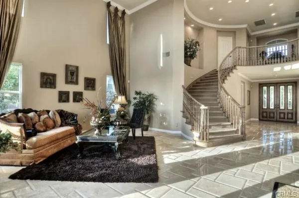 a living room with furniture and a potted plant