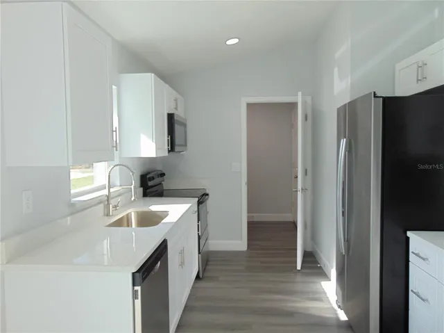 a kitchen with metallic refrigerator freezer and a dishwasher