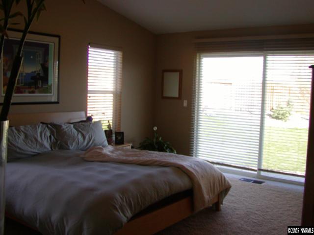15503 Quicksilver Drive Reno, NV 89511 - Photo 8 of 9 a bedroom with a large bed and a window
