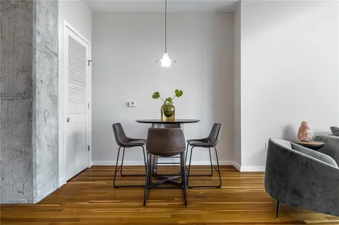 a living room with furniture and a view of kitchen