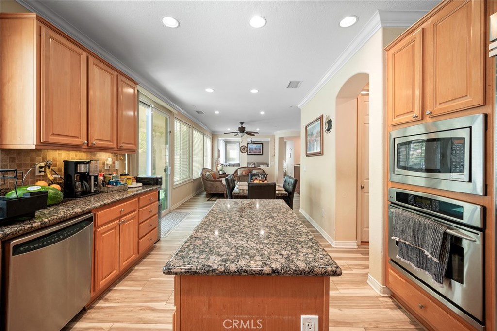 5588 California Oak Street Simi Valley, CA 93063 - Photo 28 of 75 a large kitchen with stainless steel appliances granite countertop plenty wooden cabinets counter space and a window