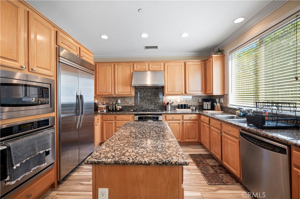 5588 California Oak Street Simi Valley, CA 93063 - Photo 30 of 75 a kitchen with stainless steel appliances granite countertop a stove a sink and a refrigerator