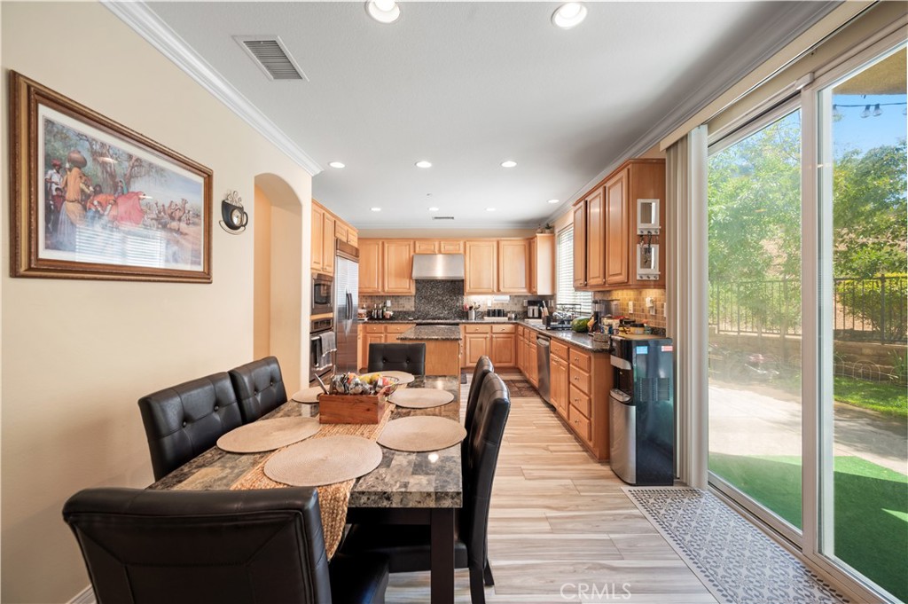 5588 California Oak Street Simi Valley, CA 93063 - Photo 33 of 75 a dining room with furniture and a floor to ceiling window
