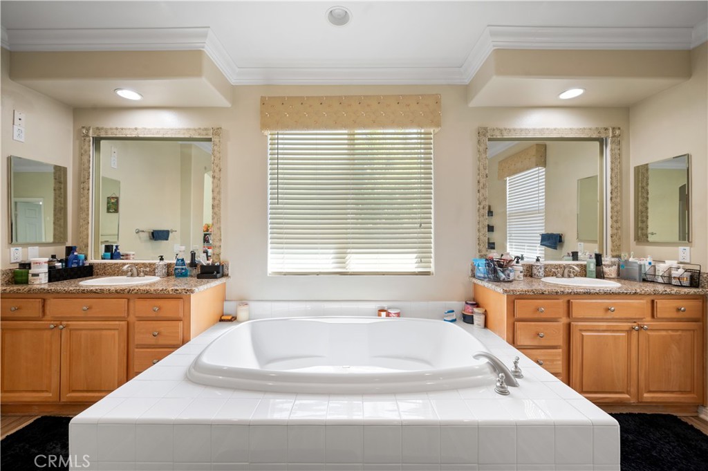 5588 California Oak Street Simi Valley, CA 93063 - Photo 42 of 75 a spacious bathroom with a granite countertop tub sink and mirror
