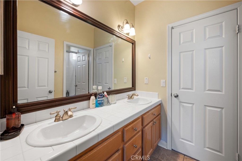 5588 California Oak Street Simi Valley, CA 93063 - Photo 44 of 75 a bathroom with a double vanity sink and a mirror
