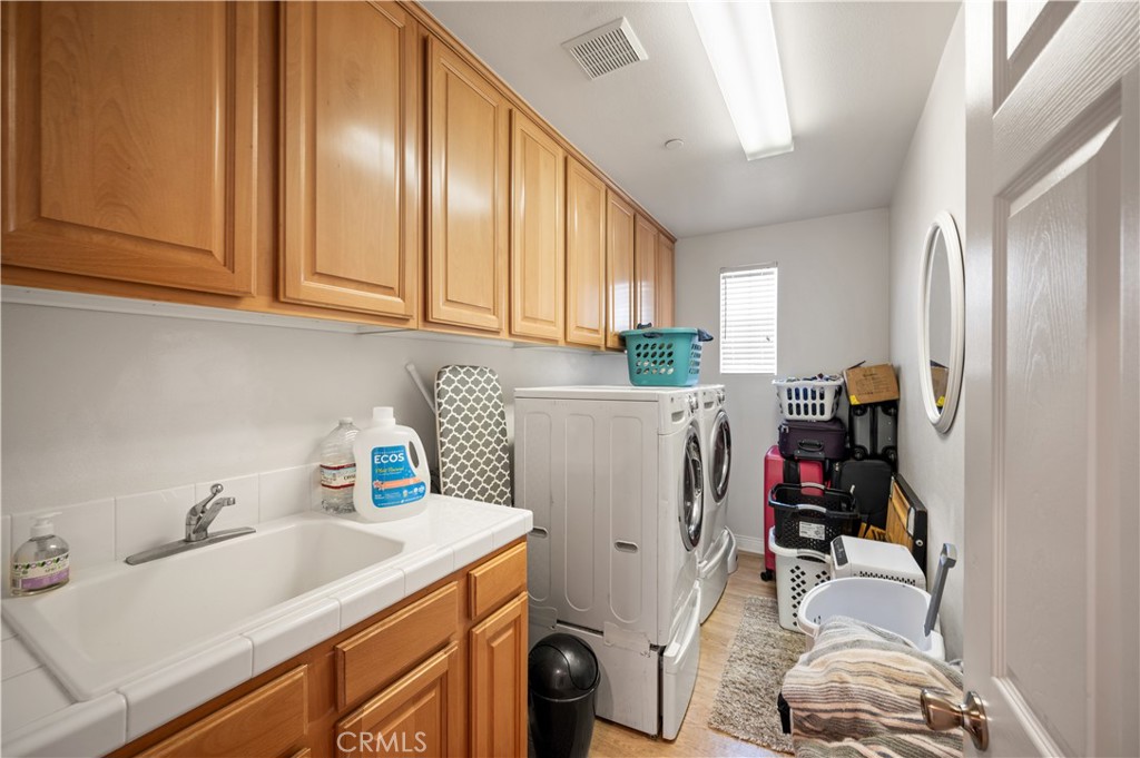 5588 California Oak Street Simi Valley, CA 93063 - Photo 61 of 75 a utility room with sink dryer and washer