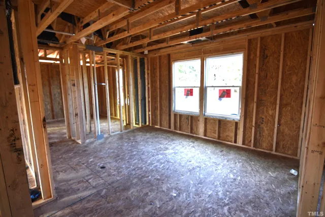 a front view of a building with glass windows and a yard