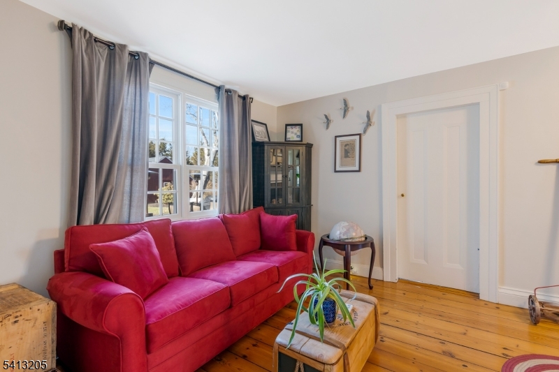 962 Old York Road Neshanic Station, NJ 08853 - Photo 5 of 33 a blue couch sitting in a living room next to a window
