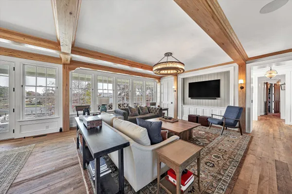 a living room with furniture and floor to ceiling windows