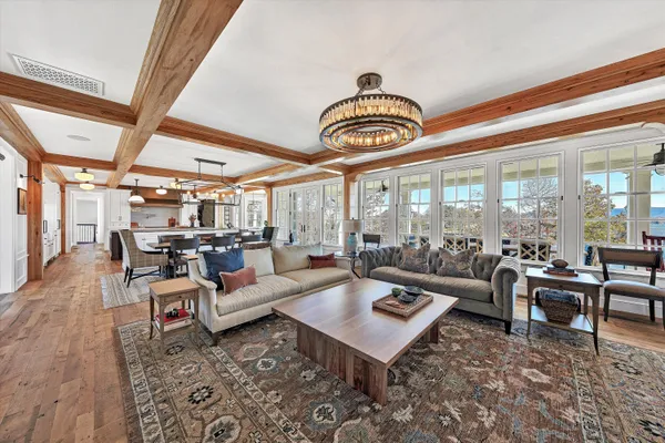 a living room with furniture and a floor to ceiling window