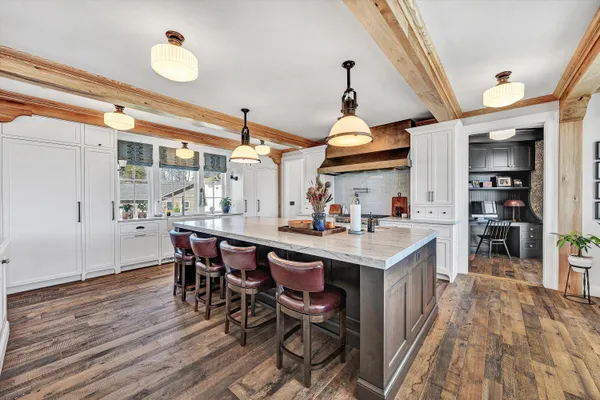 a kitchen with stainless steel appliances a sink a stove and a refrigerator