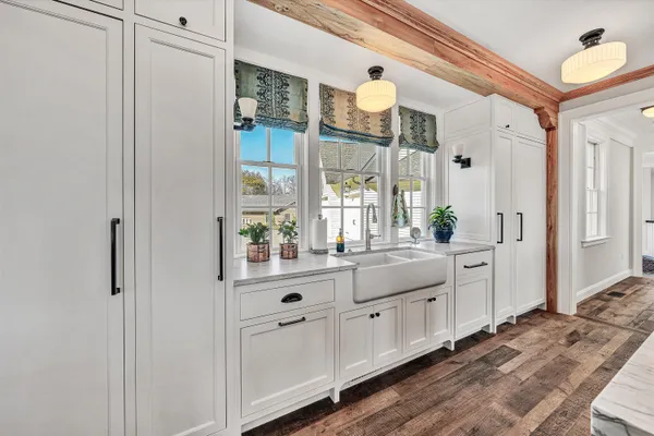 a living room with furniture a bookshelf and a large window