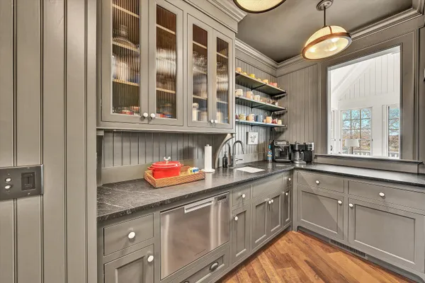 a spacious bedroom with a bed a couch and a large window