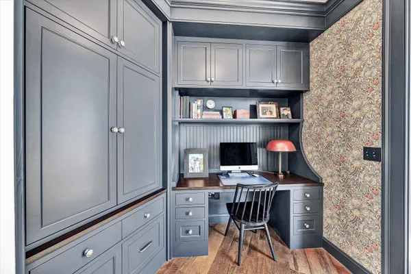 a view of a patio with a table and chairs under an umbrella