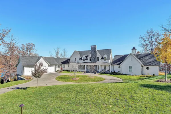 a view of a house with swimming pool and yard