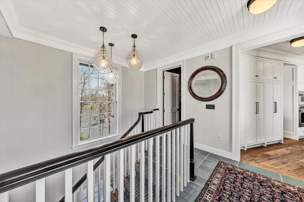 a view of a house with a big yard and large trees