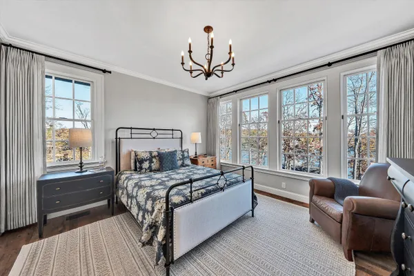 a view of a house with a yard and large tree