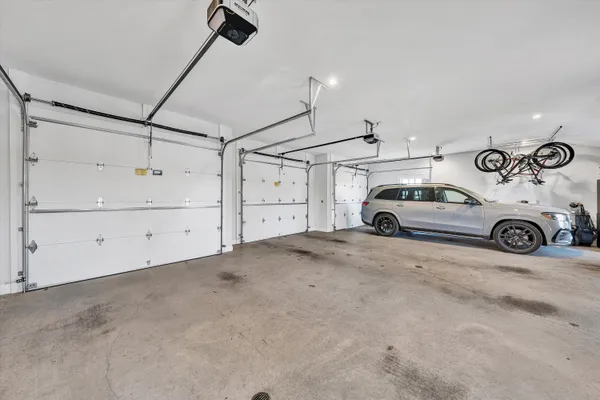 a view of a big house with a big yard and large trees