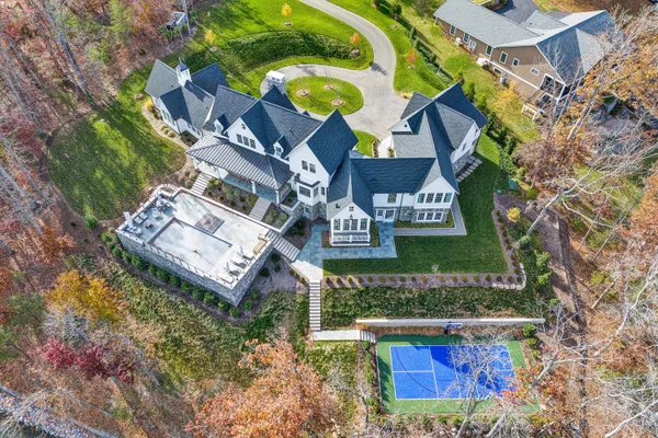 an aerial view of a house with swimming pool and outdoor space