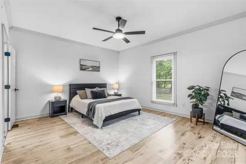 a bed room with a bed and a chair