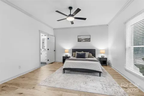 a spacious bedroom with a bed and a large window